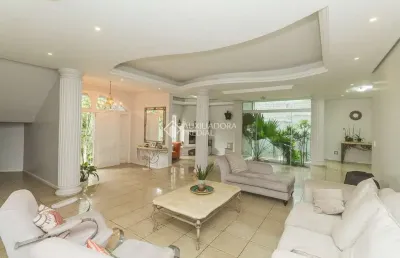 Casa com 5 quartos à venda na rua theonila carvalho da motta, 184, parque santa fé, porto alegre, 650 m2 por r$ 1.250.000