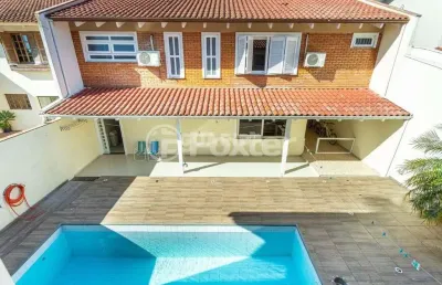 Casa em condomínio fechado com 4 quartos à venda na avenida juca batista, 1200, cavalhada, porto alegre, 300 m2 por r$ 1.200.000