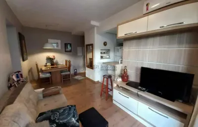 Apartamento padrão 2 dormitórios semi mobiliado com suíte, sacada e garagem