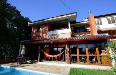 Casa com 4 quartos à venda na rua alcebíades antônio dos santos, 157, nonoai, porto alegre por r$ 1.650.000