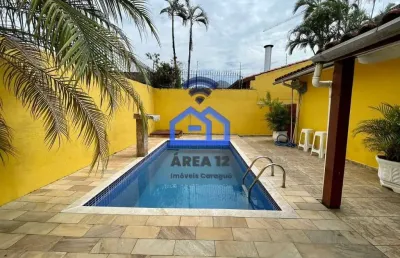 Casa à venda martim de sá com piscina, 2 dormitórios, sendo 1 suíte, sala com 2 ambientes e garagem