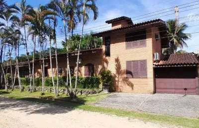 Casa em condomínio fechado com 6 suítes, piscina e área gourmet.
