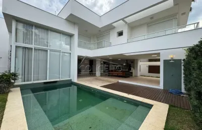 Sobrado de alto padrão para locação no condomínio alphaville piracicaba com 373,43 m² | 4 suítes com closet e sacada, 2 vagas de garagem cobertas.