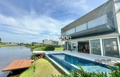 Sobrado beira lago com piscina e deck com 457m² e 5 suítes no condomínio sense em xangri-lá
