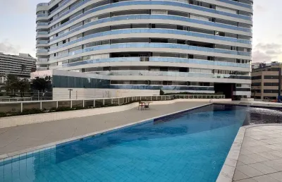 Quarto e sala vista mar em armação   salvador  suítes residence