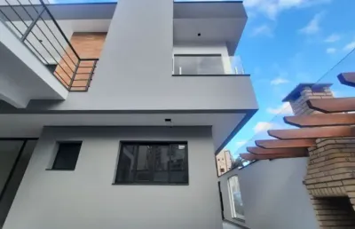 Sobrado novo com conceito moderno com 3 suítes e 2 vagas.