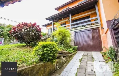 Casa com 5 quartos à venda na Rua Ângelo Passuelo, 79, Vila Nova, Porto Alegre