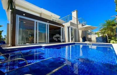 Casa em condomínio semimobiliada de 3 suítes, escritório, possui pátio, piscina e sauna,  pode ser financiada, 4 vagas, bairro estância velha canoas.