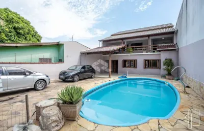 Casa com 5 dormitórios, 1 suíte, espaço gourmet e piscina. a venda no bairro rio branco em canoas-rs