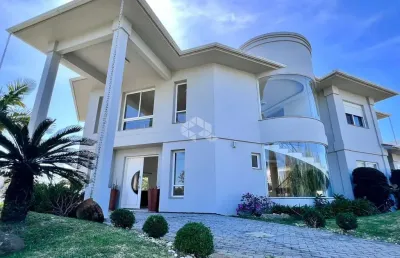 Sobrado mobiliado 4 suites condominio fechado capão da canoa rs