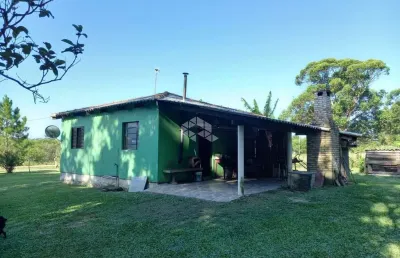 Casa de alvenaria com 2 dormitórios, sala e cozinha conjugado e churrasqueira na varanda.