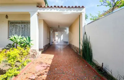 Encante-se com essa casa ainda no estilo interiorano, com terraço na frente e jardim com flores na vila madalena!