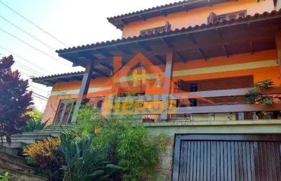 Casa com 5 quartos à venda na rua ângelo passuelo, 79, vila nova, porto alegre por r$ 650.000