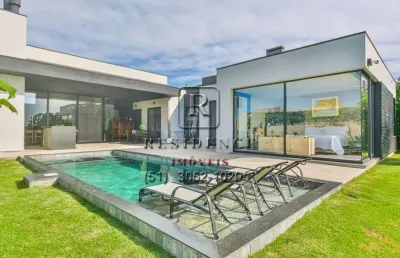 Luxuosa casa em condomínio à venda em belém novo, porto alegre-rs: 4 quartos, 4 suítes, áreas amplas e piscina aquecida!
