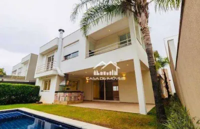 Vende magnífica casa em condomínio com 620m², 4 suítes e lazer.