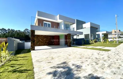 Sobrado composto por 3 suítes, sendo uma suíte master com banheira, living moderno com lareira composto por 3 ambientes,  sala de estar e jantar , abe