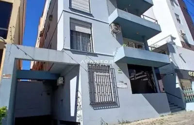 Apartamento central de 2 dormitórios, sala de estar, 2 banheiros, cozinha, área