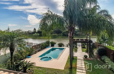 Casa em condomínio fechado com 4 quartos à venda na avenida juca batista, 9000, belém novo, porto alegre, 387 m2 por r$ 2.487.500