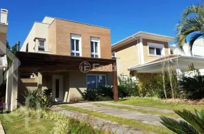 Casa em condomínio fechado com 3 quartos à venda na avenida juca batista, 8000, belém novo, porto alegre, 243 m2 por r$ 1.500.000