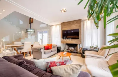 Casa em condomínio fechado com 4 quartos à venda na avenida juca batista, 8000, belém novo, porto alegre, 219 m2 por r$ 1.650.000