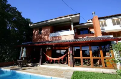 Casa com 4 quartos à venda na rua alcebíades antônio dos santos, 157, nonoai, porto alegre por r$ 1.400.000
