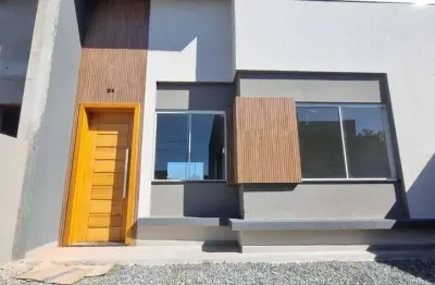 Casa nova com 2 dormitórios/ 1bwc social, 2 vagas garagem, amplo espaço de terreno na frente, em itapoá/sc.