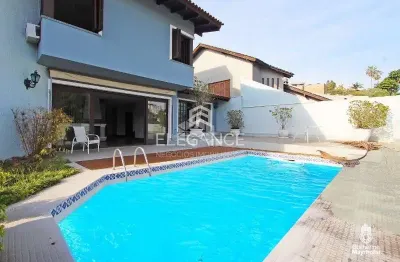 Elegance imóveis vende casa de 430m, 4 dormitórios, 3 suítes, living, piscina churrasqueira, adega e 8 vagas de garagem/box. comprar r$ 2.400.000,00