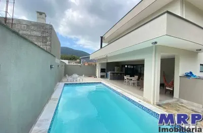 Casa à venda em ubatuba. praia da lagoinha. condomínio fechado. 4 dormitórios. com piscina.