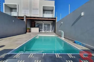 Sobrado amplo, semi mobiliado com  03 quartos sendo 01 suíte e piscina - excelente padrão de acabamento, localizado no baln. cambiju á 100m  da praia.