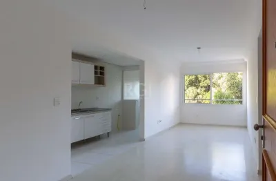 Apartamento de dois dormitórios, uma suíte, living, cozinha com churrasqueira, área de serviço, banheiro social e uma vaga de garagem.