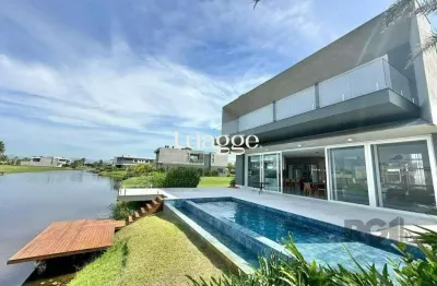 Sobrado beira lago com piscina e deck com 457m² e 5 suítes no condomínio sense em xangri-lá