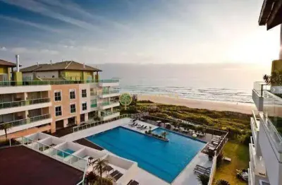 Frente mar à venda na praia do santinho! sacada com jacuzzi, semi mobiliado, 2 quartos e 1 vaga de garagem.