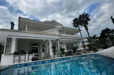 Mansão com 5 suítes à venda em florianópolis/sc, condomínio fechado, 991 m², elevador, piscina e 4 vagas - bairro cacupé.