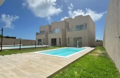 Residencial exclusivo em condomínio fechado lado praia-barra do jacuípe. 3/4 sendo 2 suítes. piscina e garagem.
