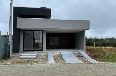 Casa em condomínio com 3 dormitórios, 2 suítes, churrasqueira, lareira e 2 vagas.