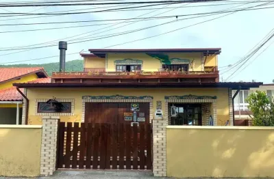 Casa 4 dormitórios sendo um térreo, 2 salas, cozinha planejada, deck parte superior, 300 mts praia.