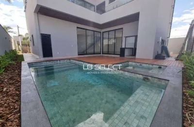 Sobrado luxuoso no condomínio golden village com quatro suítes e varanda gourmet completa.
