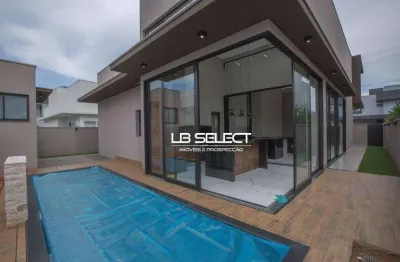 Casa no condomínio alphaville ii com três suítes, escritório com lavabo e varanda gourmet completa.