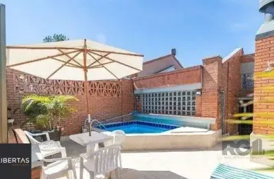 Casa em condomínio fechado com 3 quartos à venda na Avenida Jacuí, 978, Cristal, Porto Alegre