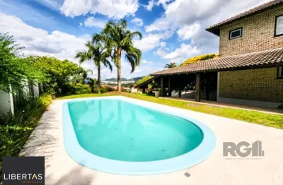 Casa em condomínio fechado com 5 quartos à venda na Avenida Firmino Octávio Bimbi, 255, Cavalhada, Porto Alegre