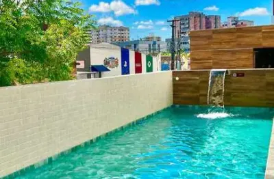 Apartamento novo com 2 quartos a poucos passos da praia 