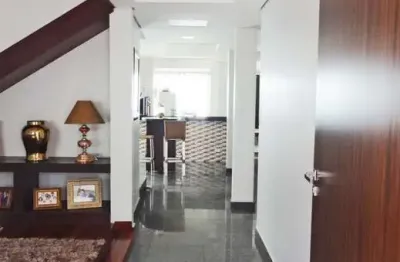 Casa tipo sobrado, com 320 m² de área construída, com 4 quartos, 3 salas e 4 vagas de garagem.