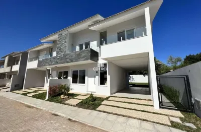 Casa em condomínio fechado com 3 dormitórios, suíte e 2 vagas de garagem