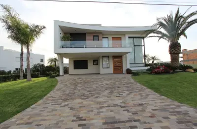 Casa em condomínio fechado com 4 quartos à venda na rua rio jacuí, 1331, atlântida, xangri-lá por r$ 3.710.000