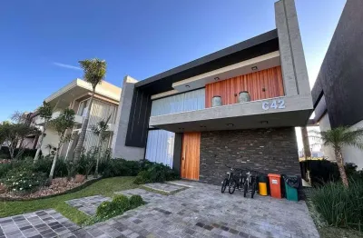 Casa em condomínio fechado com 5 quartos à venda na estrada do mar, 33, parque antártica, capão da canoa, 325 m2 por r$ 4.800.000
