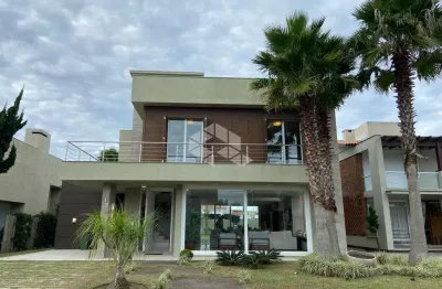 Sobrado com 5 dormitórios, 2 vagas, no condomínio ventura club, xangri-lá/rs