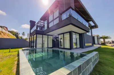 Casa de alto padrão nova no condomínio fechado reservas do lago em nova santa rita. terreno de esquina com 504m², 4 dormitórios, sendo 2 suítes.