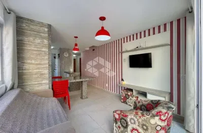 Apartamento com amplo terraço, 2 dormitórios com suíte em capão da canoa.