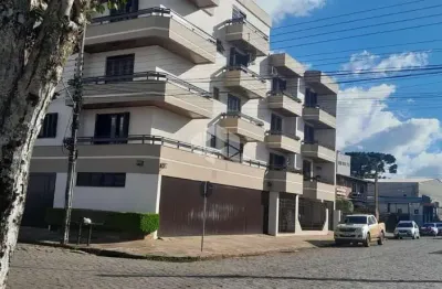Apartamento de dois dormitórios e vaga de garagem no centro de vacaria