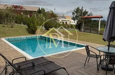 Chácara  em condomínio fechado com 1.200 m² de terreno, 320 m² de área construída e piscina de 50 m